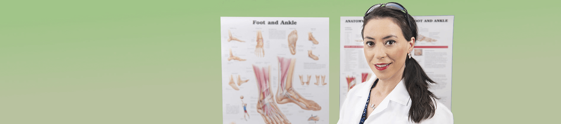 Female podiatrist in front of poster of foot anatomy