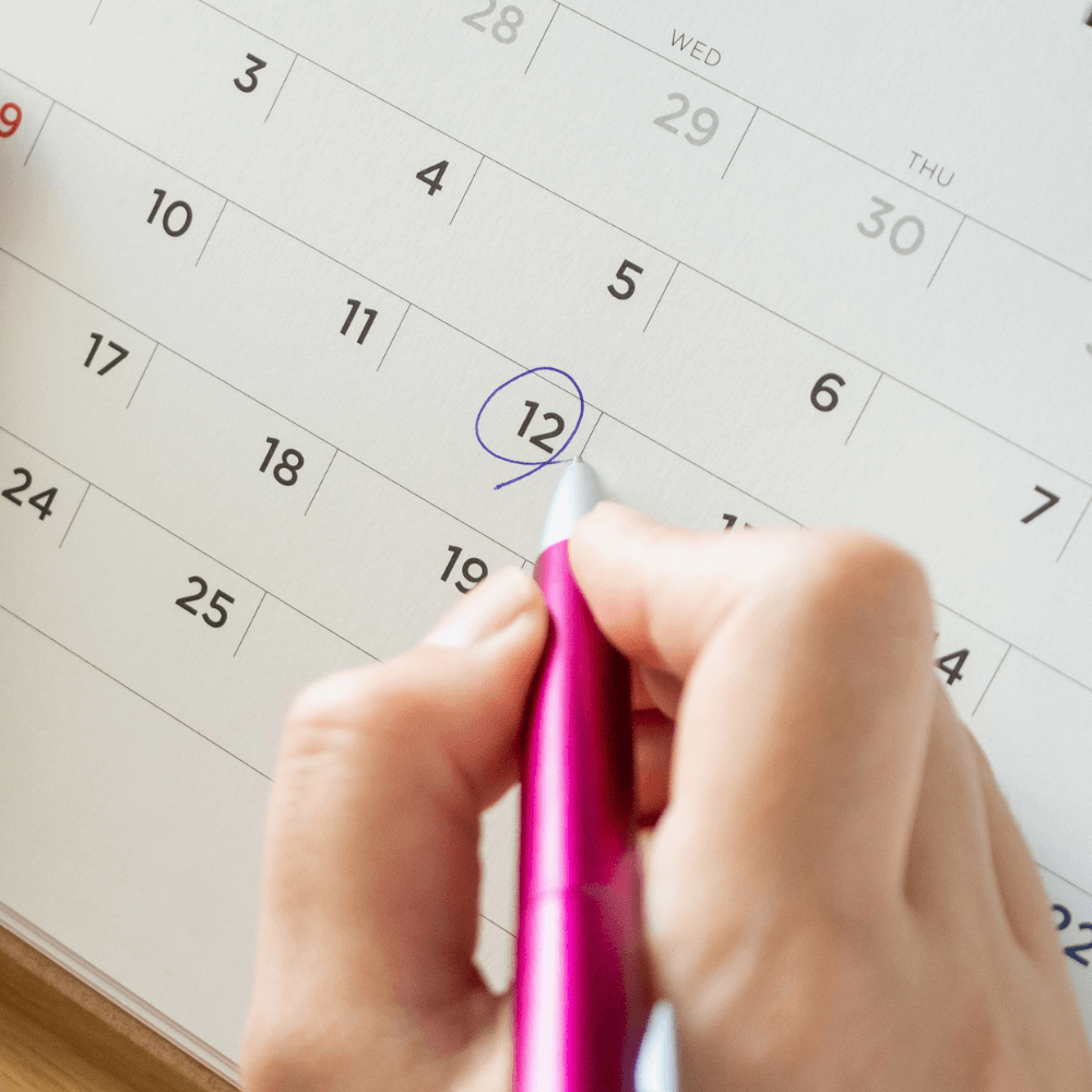 Close up of patient marking a date on a calendar