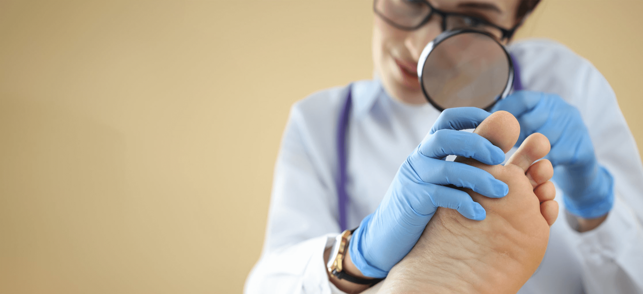 Female podiatrist inspecting foot with magnifying glass