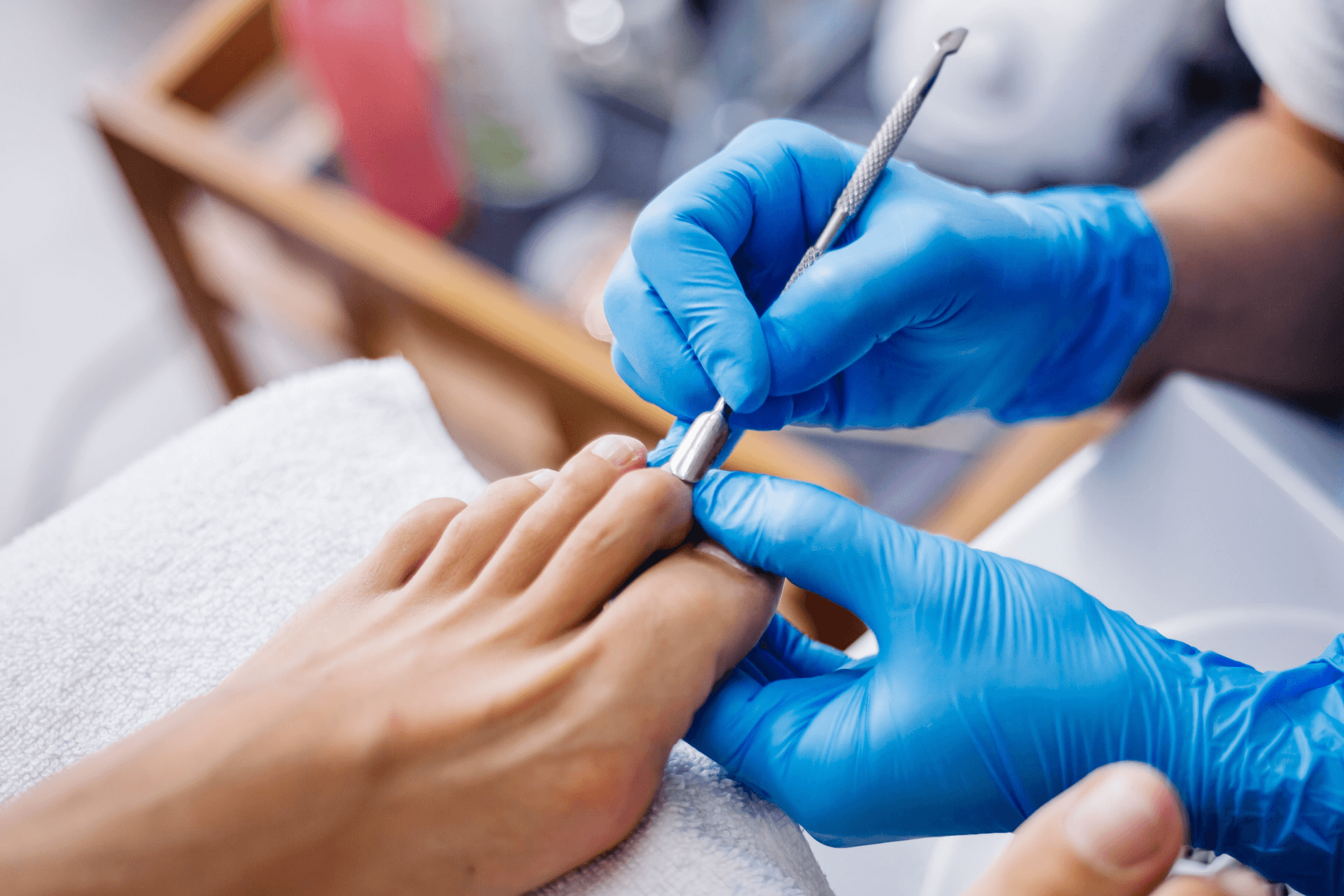 Podiatrist treating patients cuticles